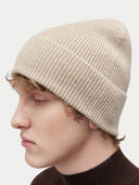 Unisex Organic Cashmere Rib Knit Beanie Warm Grey  worn by model, detail view on white background
