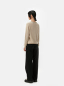 Women's Warm Grey Cashmere Crew Neck Sweater worn by model, back view on white background