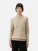 Women's Warm Grey Cashmere Crew Neck Sweater worn by model, detail view on white background