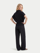 Women's Black Cashmere Asymmetrical Top worn by model, back view on white background