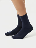 Unisex Cashmere Trim Knit Bed Socks Navy Blazer worn by model, detail view on white background