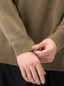 Unisex High-Neck Cashmere Sweater Aloe worn by model, detail view, on white background