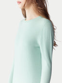 Women's Seledan Cashmere Crew Neck Sweater worn by model, side view on white background.
