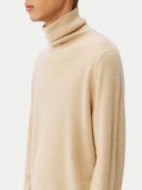 Men's Beige Cashmere Basic Turtle Neck Sweater Beige worn by model, detail view on white background
