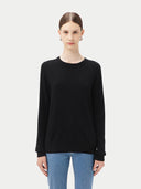 Women's Black Cashmere Crewneck Sweater worn by model, detail view on white background