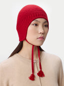 Ultimate Warmth Knit Tie Hat Chili Pepper   worn by model, side view on white background
