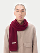 Unisex Cashmere Jersey Knit Scarf Bordeaux worn by model, detail view on white background