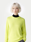 Women's Sunny Lime Cashmere Crewneck Sweater worn by model, detail view on white background 