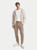 Men's Cashmere Jogger Taupe worn by model, front view on white background
