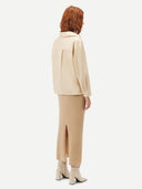 Women's Beige  Cashmere Midi Skirt worn by model, back view on white background