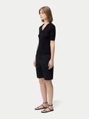 Cashmere Silk Women's Polo Shirt Black   worn by model, side view on white background