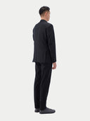 Men's Black single-breasted cashmere blazer worn by model, back view on white background