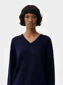 Women's Navy Cashmere V-Neck Sweater worn by model, detail view on white background