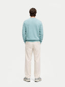 Men's Blue Haze Cashmere Crewneck Sweater worn by model, back view on white background 