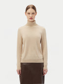 Women's Beige Cashmere Basic Turtle Neck Sweater worn by model, detail view on white background