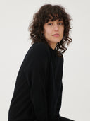 Women's Black Cashmere Full-Zip Cardigan worn by model, detail view on white background